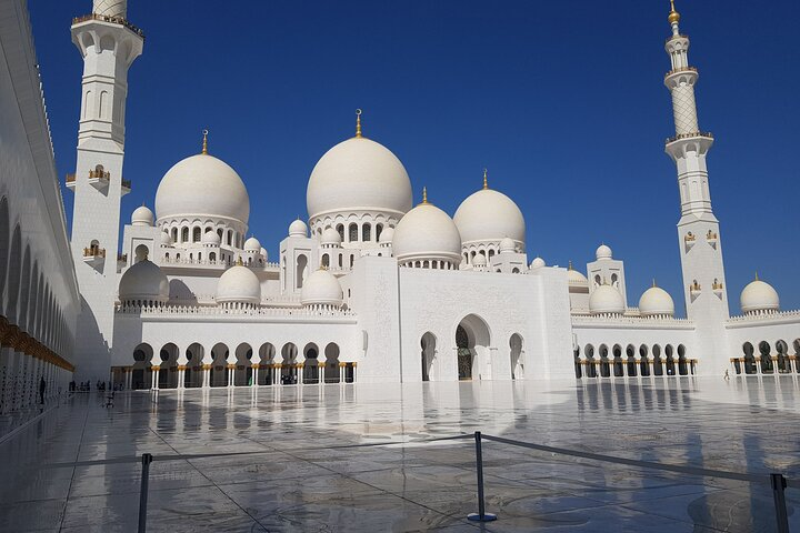 Immerse yourself in the grandeur of Sheikh Zayed Grand Mosque a stunning masterpiece showcasing architectural brilliance intricate floral mosaics and captivating chandelier designs perfect for a memorable half-day experience.